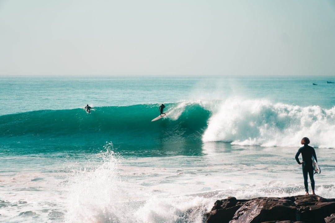 Surfing in Morocco — a surfer riding a right-hand point break at Anchor Point near Taghazout in morning light