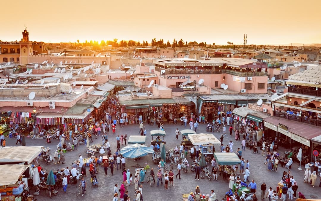 Is Marrakech safe — Jemaa el-Fna square crowd at dusk with food stalls and Koutoubia minaret behind, warm light