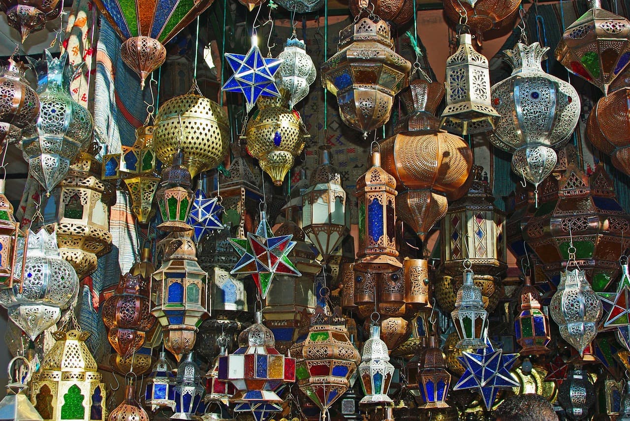 Is Morocco expensive — a busy Marrakech souk market where most travel spending happens