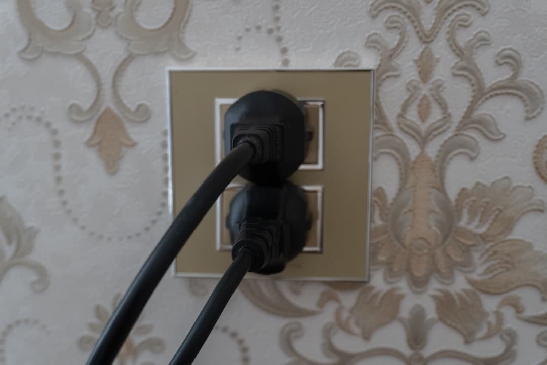Morocco plug type — close-up of a Type C/E wall socket with a two-round-pin European plug inserted