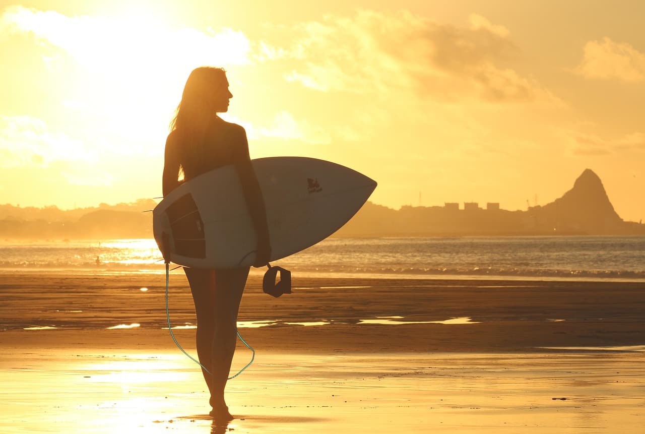 Surfing in Morocco for beginners — a group learning in the whitewater with an instructor at a sandy beach break near Tamraght